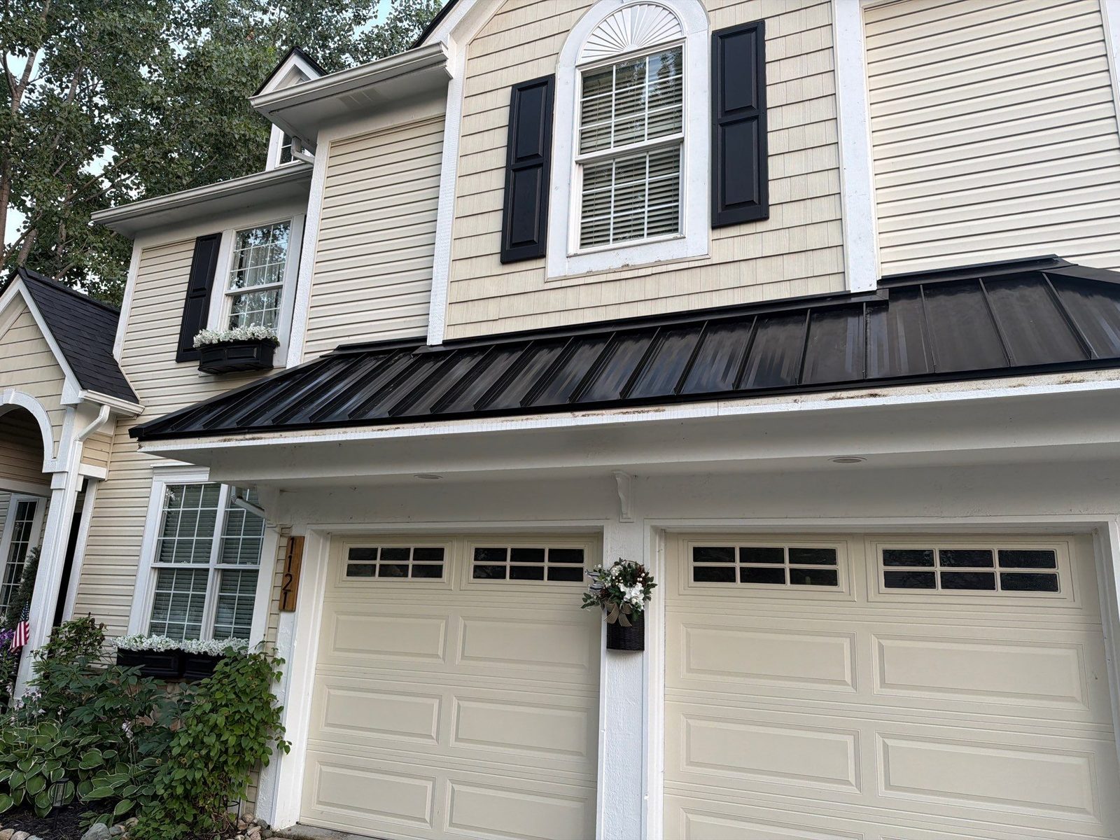 Black standing seam metal roof with landscaping