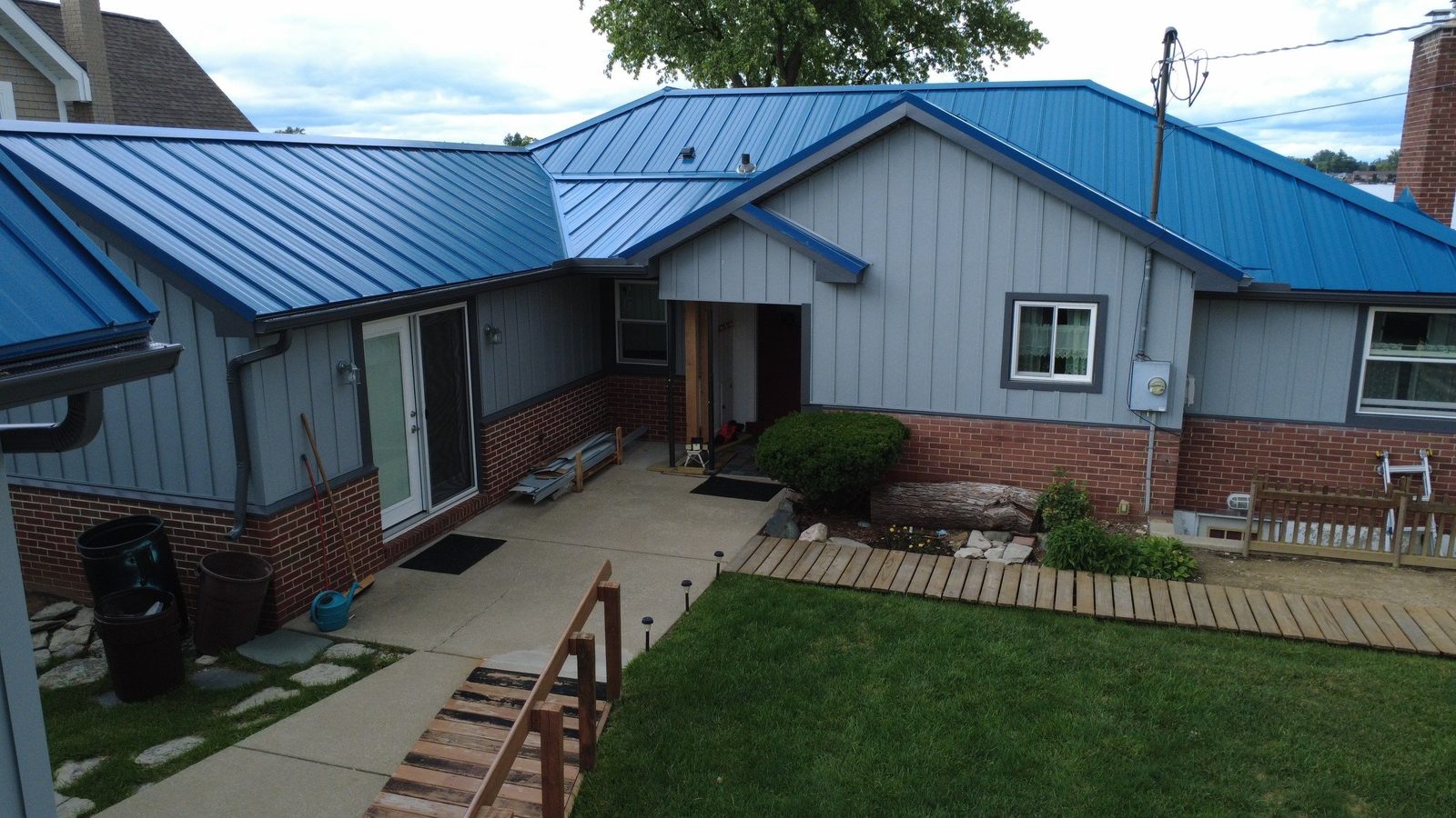 Blue standing seam roof on a brick ranch