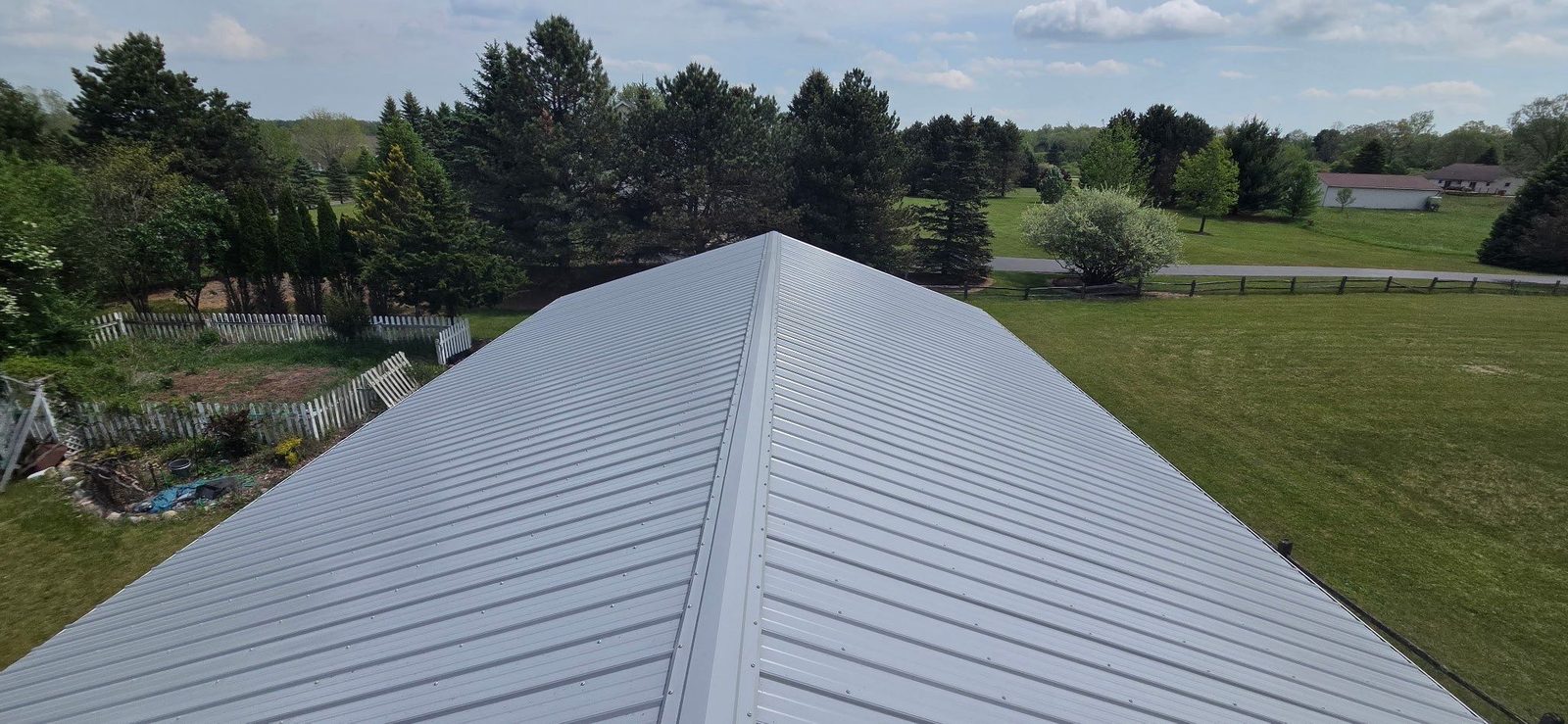 Exposed fastener metal roof on a barn and stable