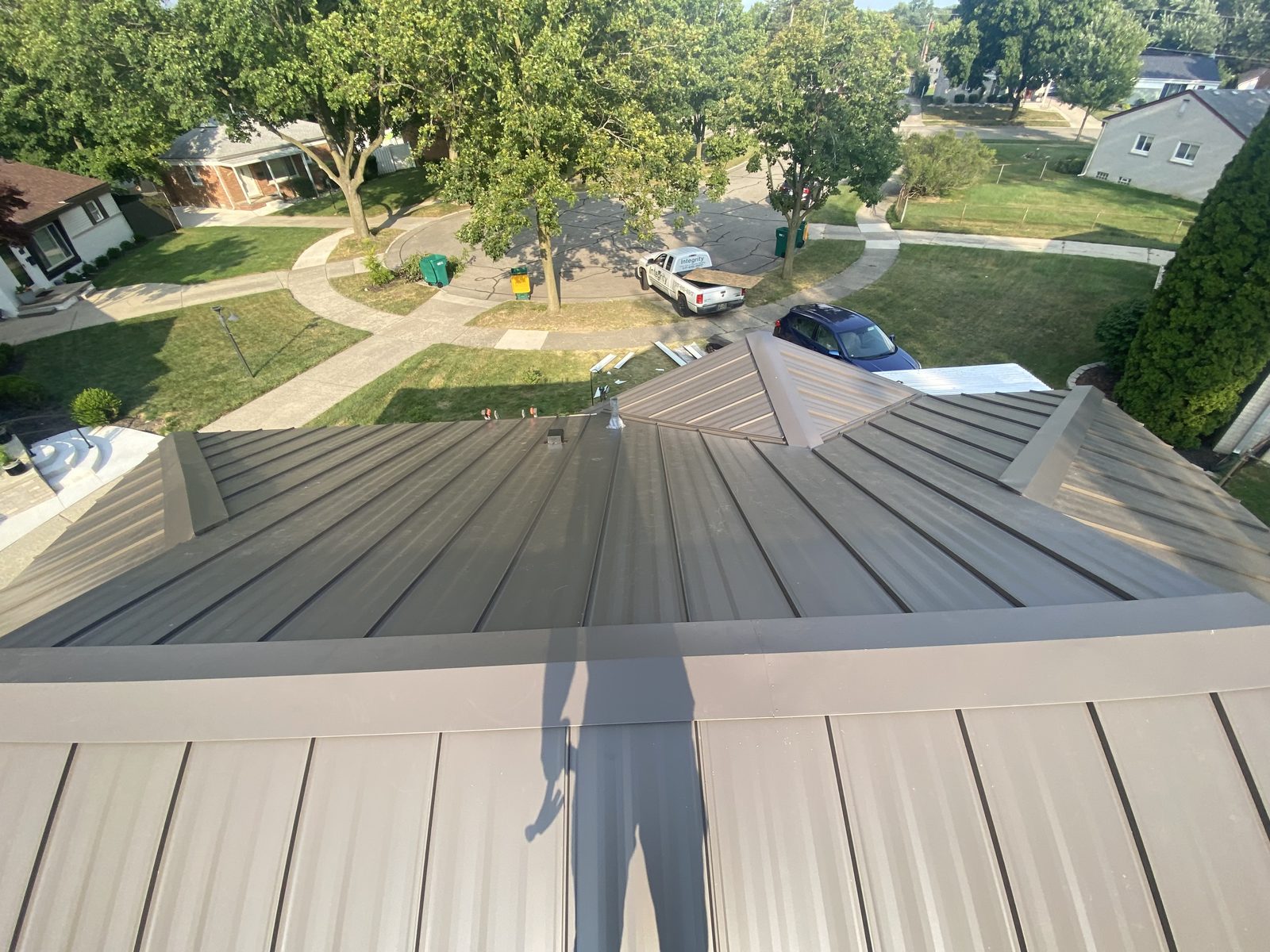 Charcoal standing seam roof, aerial view over the neighborhood