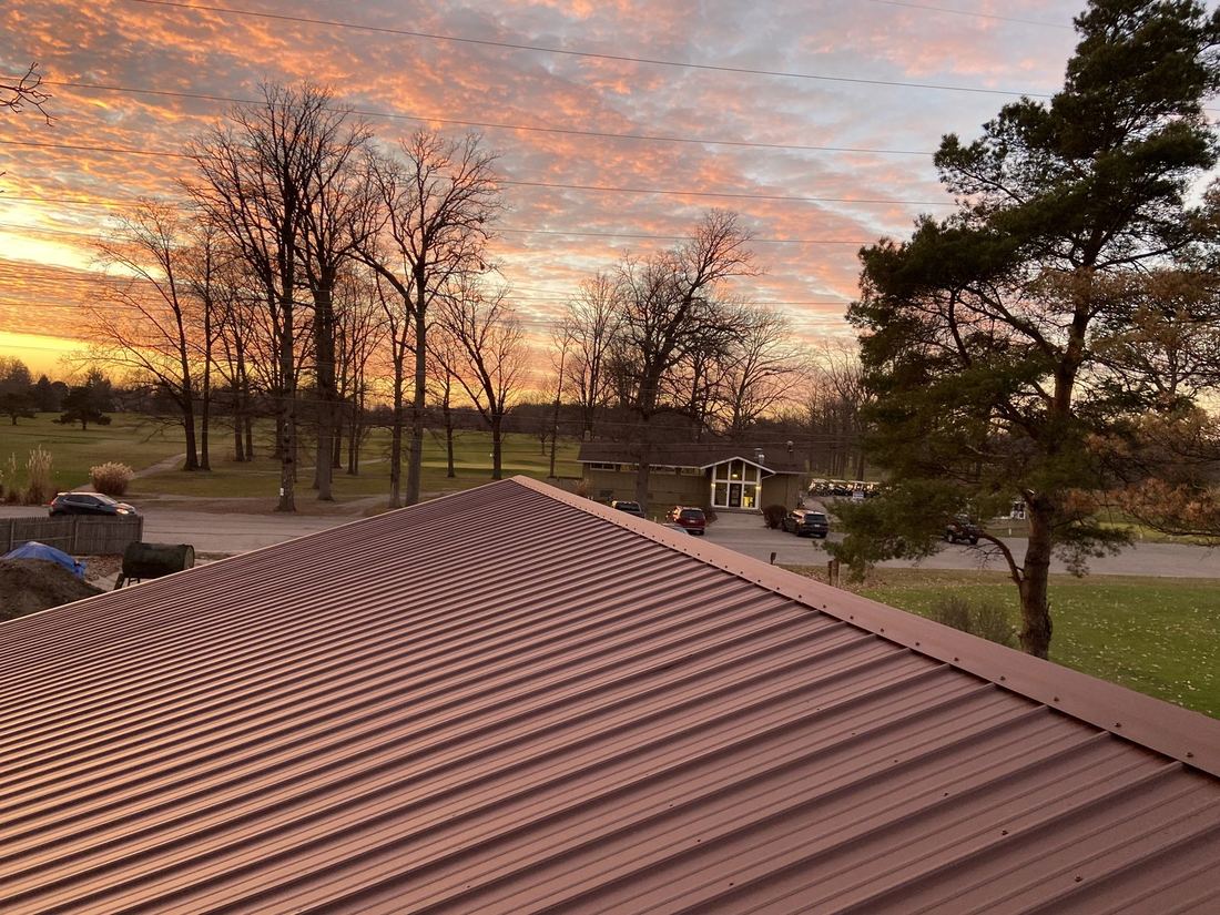 Exposed fastener metal roof at sunset
